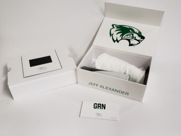 Full view of everything included in the UVU men's basketball custom marketing box, including video screen, t-shirt, season passes and more.