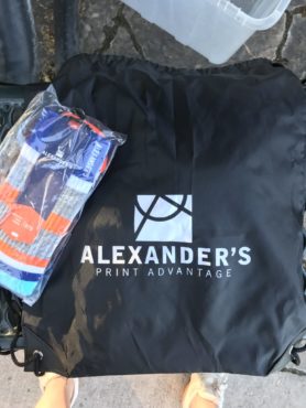 Alexander's branded drawstring bag and socks at the golf tournament